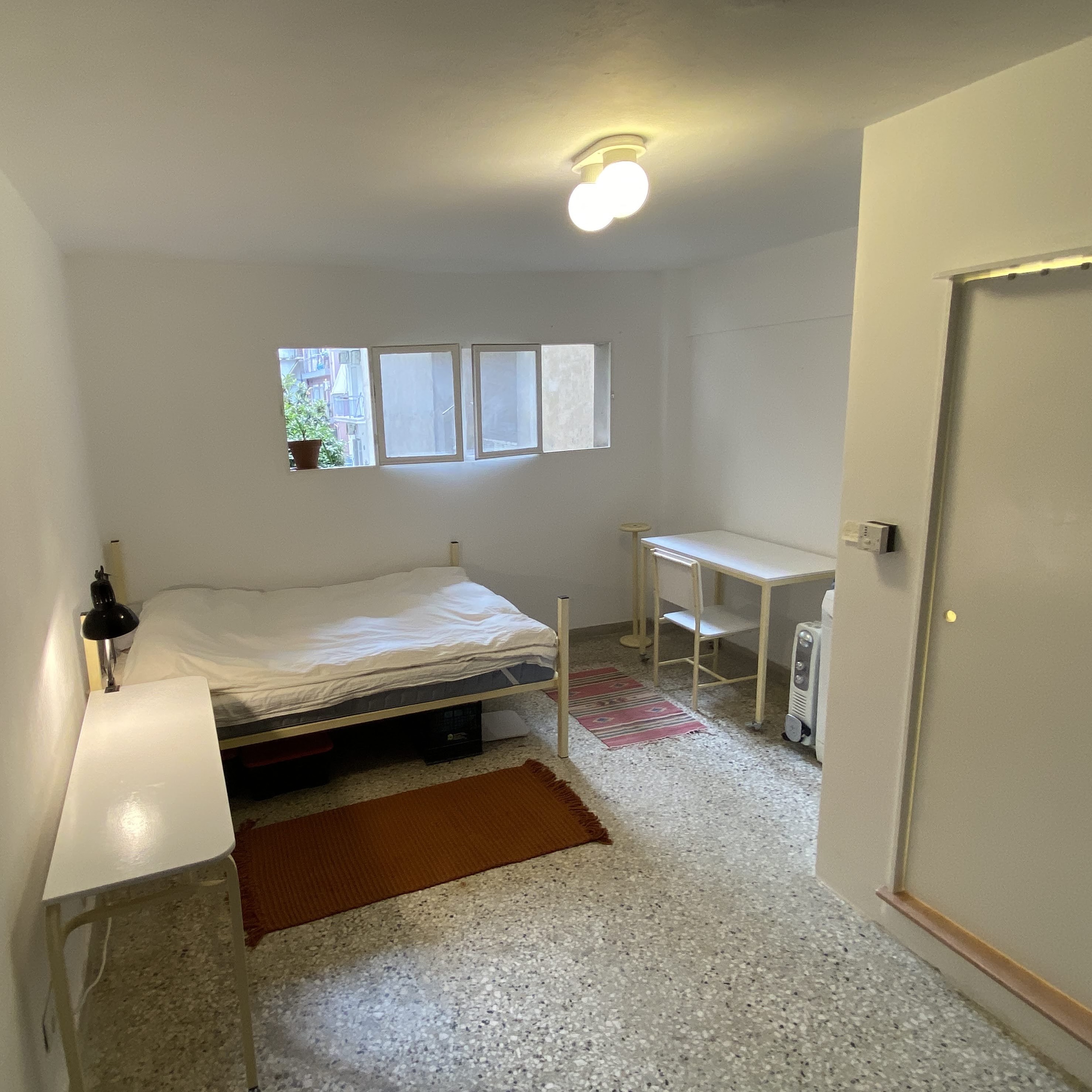 Bedroom with double bed and desk